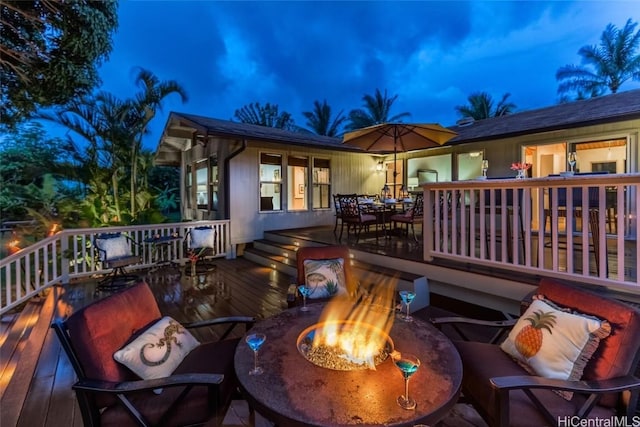 deck at dusk with a fire pit