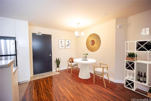 dining space with dark hardwood / wood-style flooring