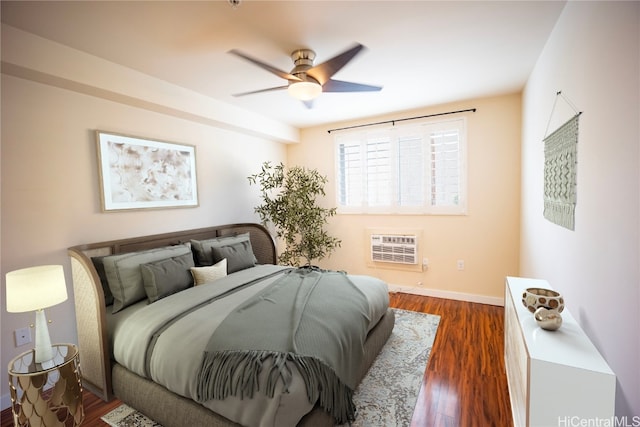 bedroom with a wall unit AC, ceiling fan, and dark hardwood / wood-style flooring