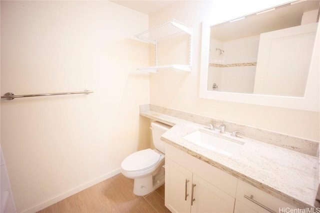 bathroom featuring vanity, toilet, and wood-type flooring