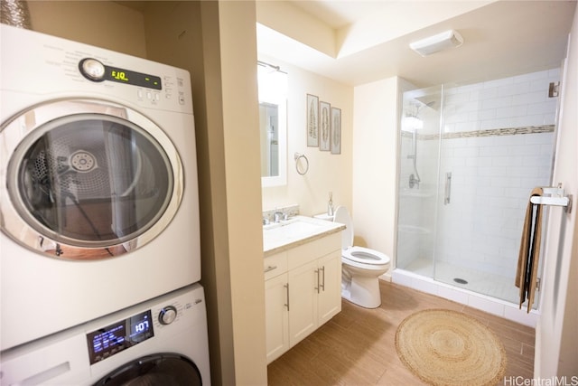 washroom featuring sink and stacked washer / dryer