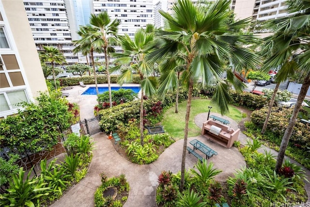 view of home's community with a swimming pool and a patio