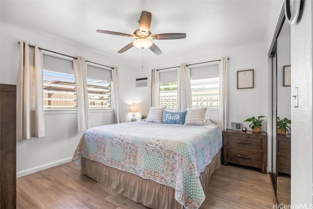 bedroom with ceiling fan and light hardwood / wood-style floors