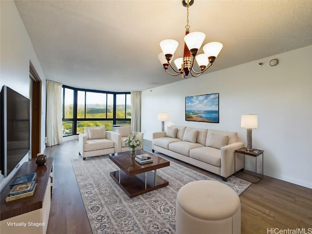 living room featuring hardwood / wood-style floors, floor to ceiling windows, and a chandelier