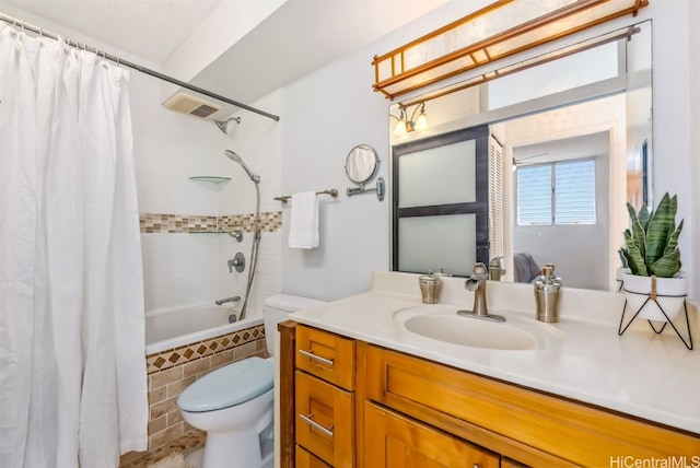 full bathroom with vanity, toilet, and shower / bath combo with shower curtain