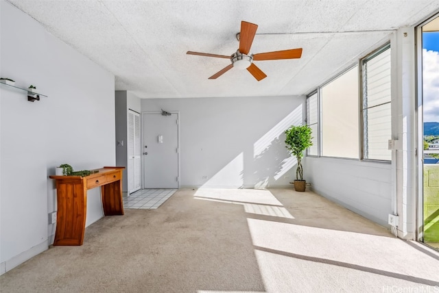 sunroom / solarium with plenty of natural light and ceiling fan