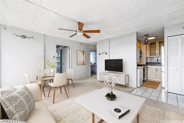 living room featuring ceiling fan and light tile patterned floors