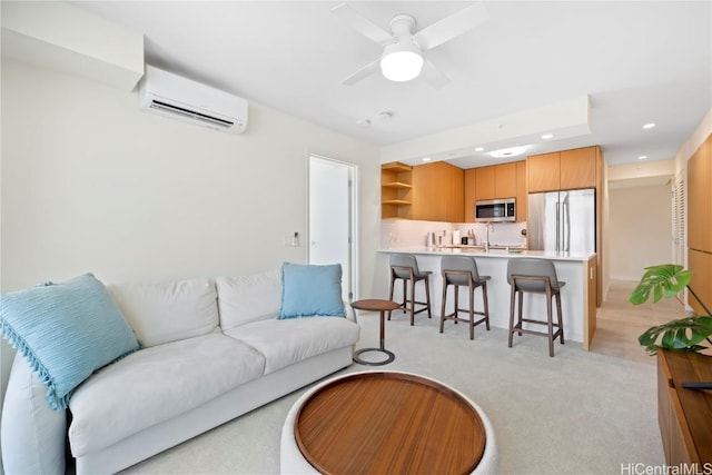 living room featuring a wall mounted air conditioner, ceiling fan, and light colored carpet