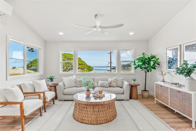 interior space with ceiling fan, lofted ceiling, and an AC wall unit