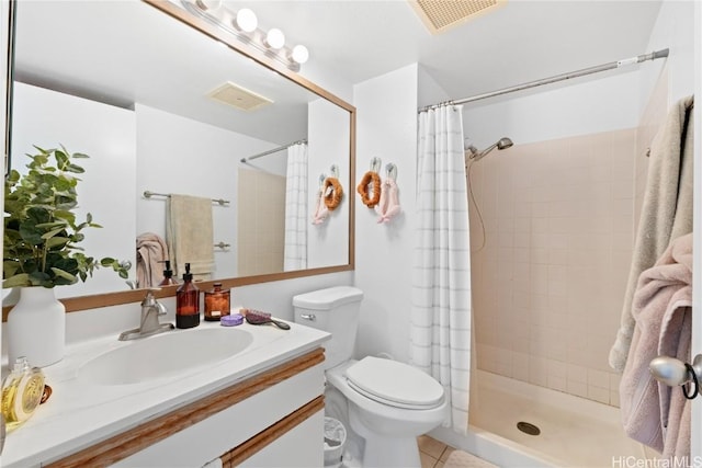 bathroom with tile patterned floors, curtained shower, vanity, and toilet