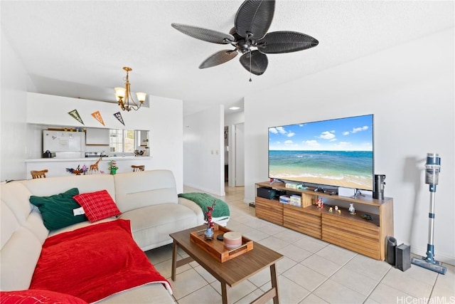 tiled living room featuring ceiling fan with notable chandelier and a textured ceiling