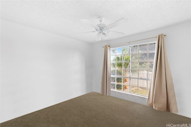 spare room with carpet flooring, ceiling fan, and a textured ceiling