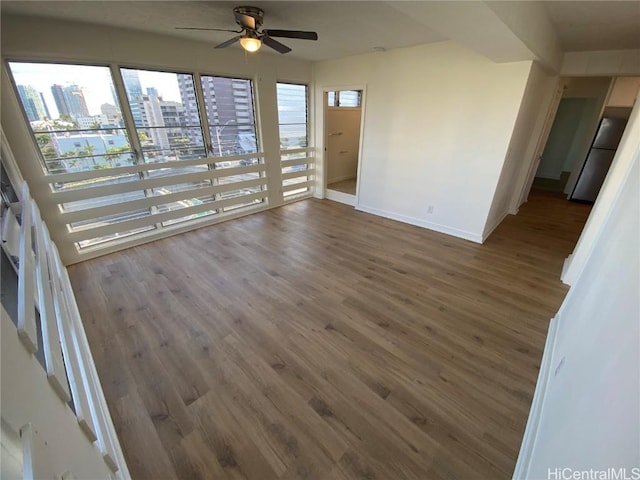 unfurnished room featuring dark hardwood / wood-style floors and ceiling fan