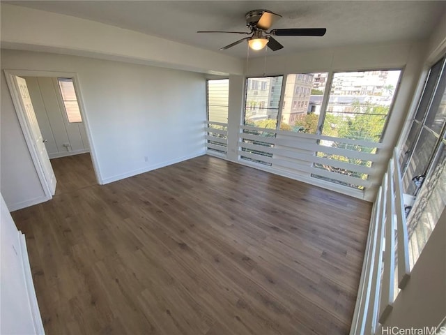 spare room with dark hardwood / wood-style floors and ceiling fan