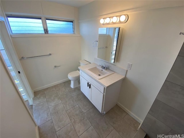 bathroom with tile patterned flooring, vanity, and toilet