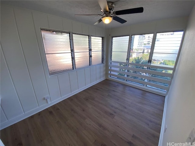 spare room featuring ceiling fan and dark hardwood / wood-style flooring