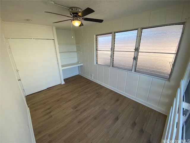 unfurnished bedroom featuring ceiling fan, a closet, and dark hardwood / wood-style floors