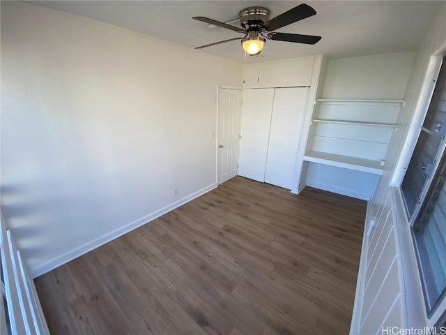 unfurnished bedroom with ceiling fan, a closet, and dark hardwood / wood-style floors