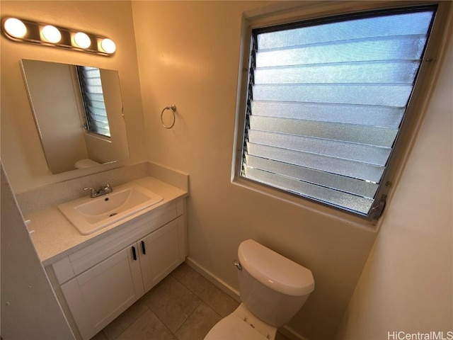 bathroom featuring tile patterned floors, vanity, and toilet