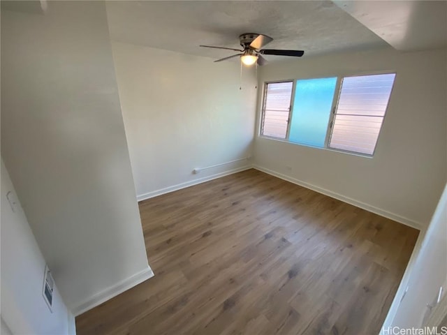 spare room featuring hardwood / wood-style flooring and ceiling fan