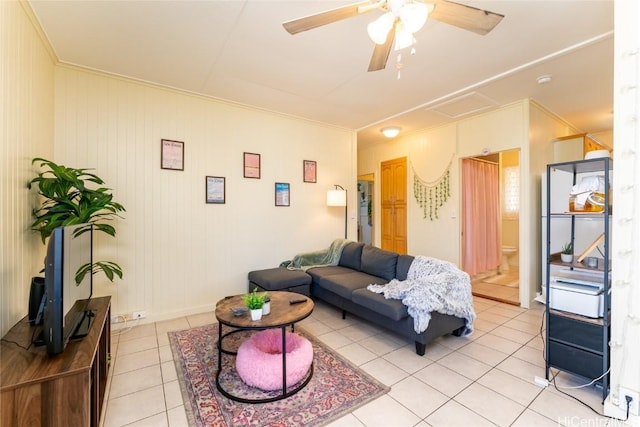 living room featuring ceiling fan, light tile patterned flooring, and ornamental molding