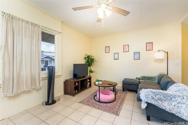 living room with ceiling fan, light tile patterned floors, and ornamental molding