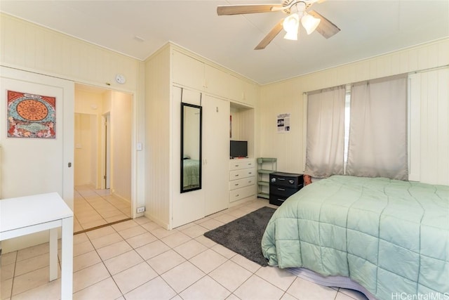 tiled bedroom with ceiling fan and crown molding