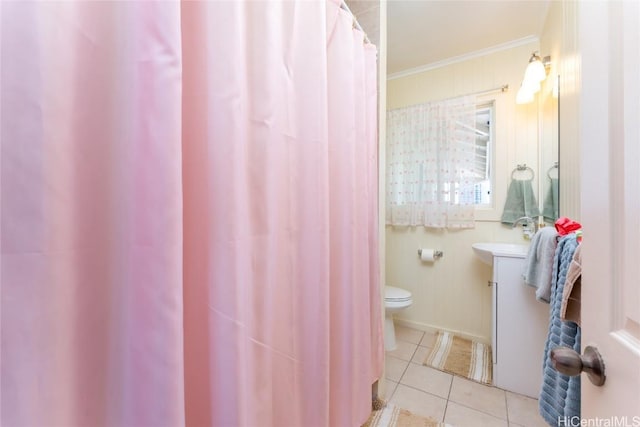 bathroom with tile patterned floors, toilet, vanity, and ornamental molding