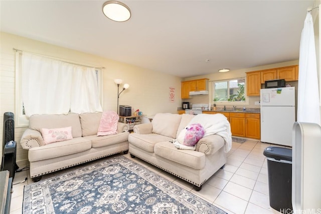 tiled living room featuring sink