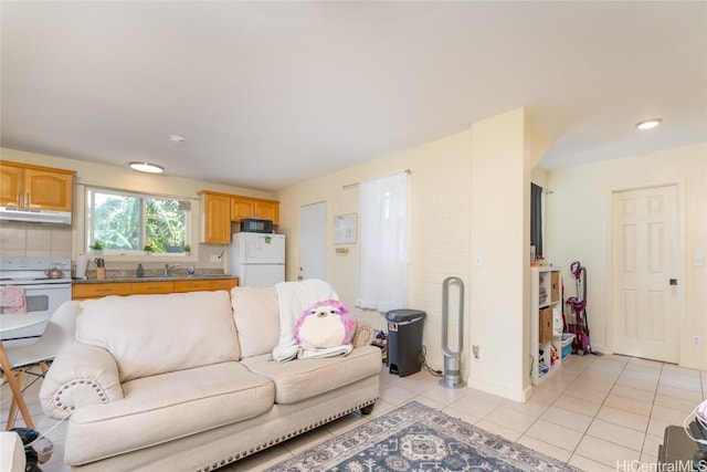 living room with sink and light tile patterned flooring