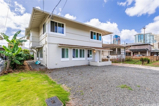 rear view of property featuring a yard