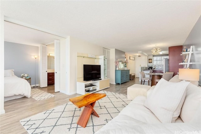 living room featuring a textured ceiling and light hardwood / wood-style flooring