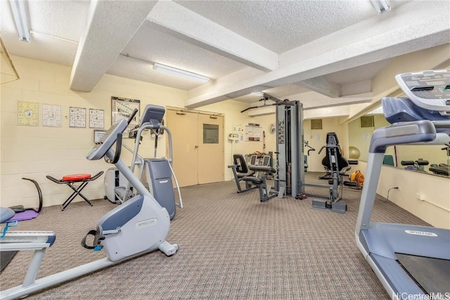 exercise room with carpet flooring and a textured ceiling