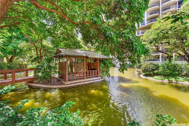 view of home's community with a gazebo and a water view