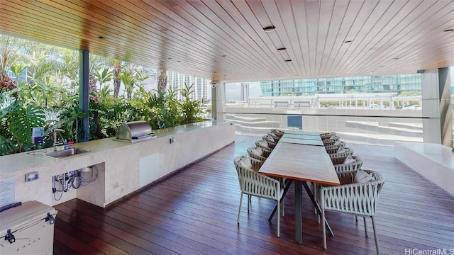 exterior space featuring grilling area, sink, and an outdoor kitchen