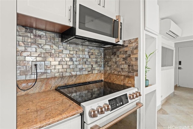 kitchen with white cabinets, white range oven, a wall unit AC, and tasteful backsplash