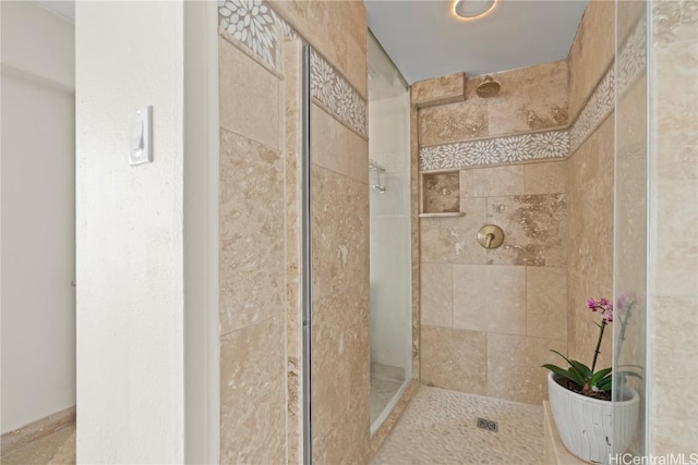 bathroom with a tile shower