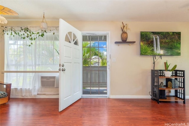 doorway with dark hardwood / wood-style flooring and a wall mounted AC