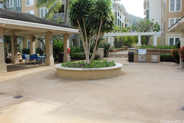 view of property's community with a gazebo, a pergola, and a patio