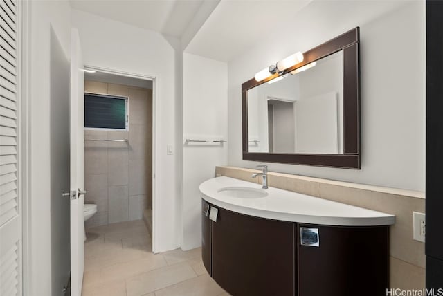 bathroom with tile patterned flooring, vanity, and toilet