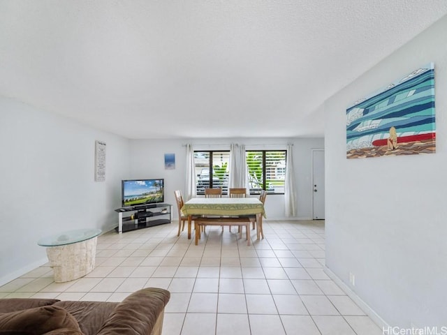 tiled dining room with a textured ceiling