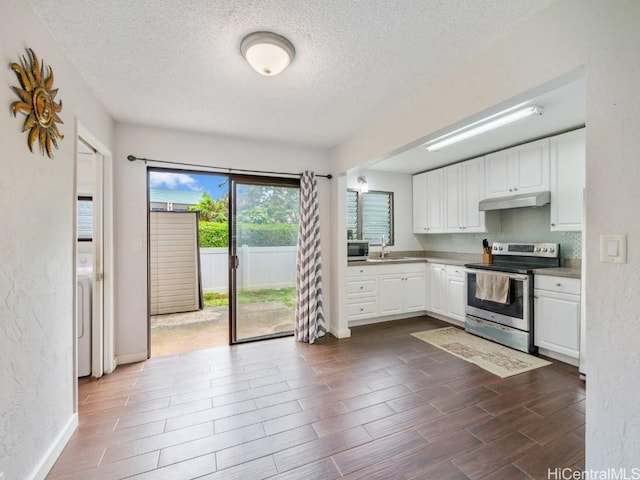 kitchen featuring white cabinets, appliances with stainless steel finishes, a textured ceiling, and sink