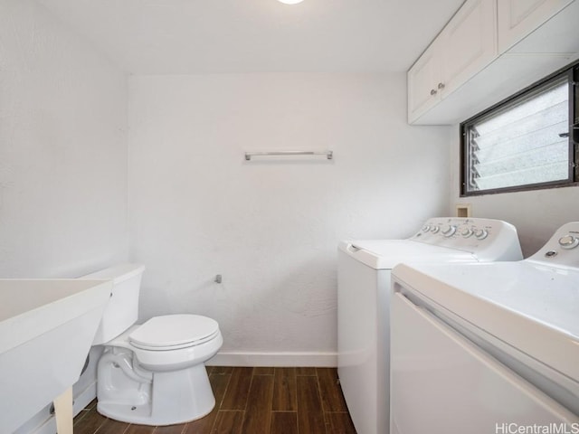 bathroom with toilet, sink, and washing machine and clothes dryer