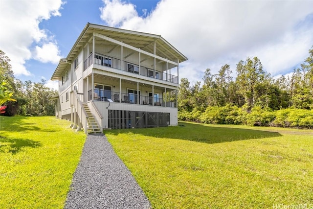 rear view of property featuring a lawn