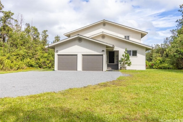 view of front of home featuring a garage and a front yard