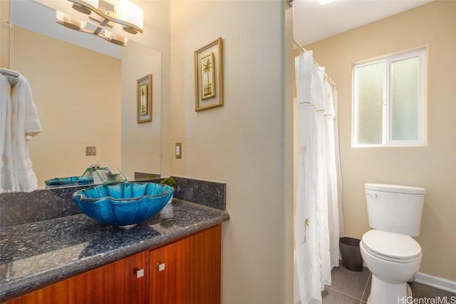 bathroom featuring tile patterned floors, vanity, and toilet