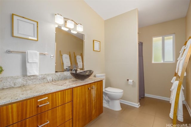 bathroom with tile patterned flooring, vanity, and toilet