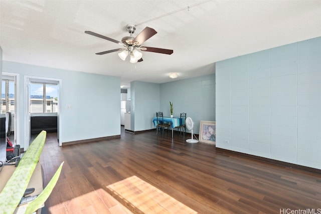 interior space with dark hardwood / wood-style floors, ceiling fan, and a textured ceiling