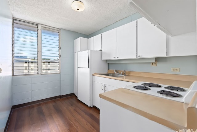 kitchen featuring white appliances, sink, dark hardwood / wood-style floors, a textured ceiling, and white cabinetry