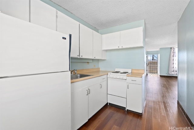 kitchen with white cabinets, white appliances, sink, and a textured ceiling